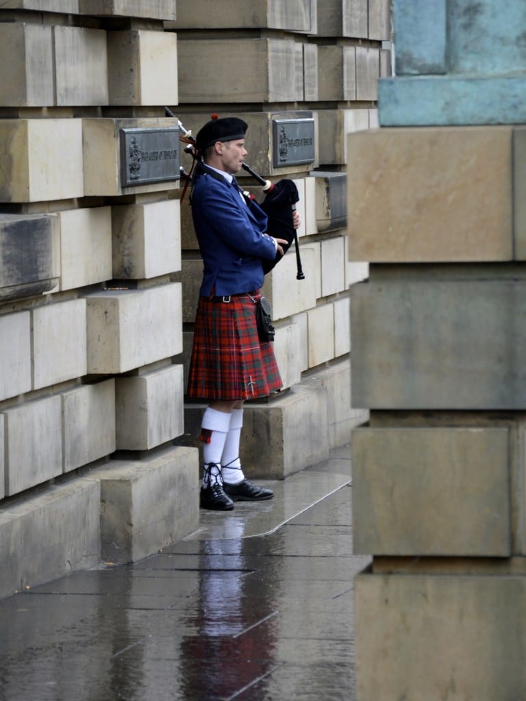on the streets in Edinburgh, Piper in a traditional kilt