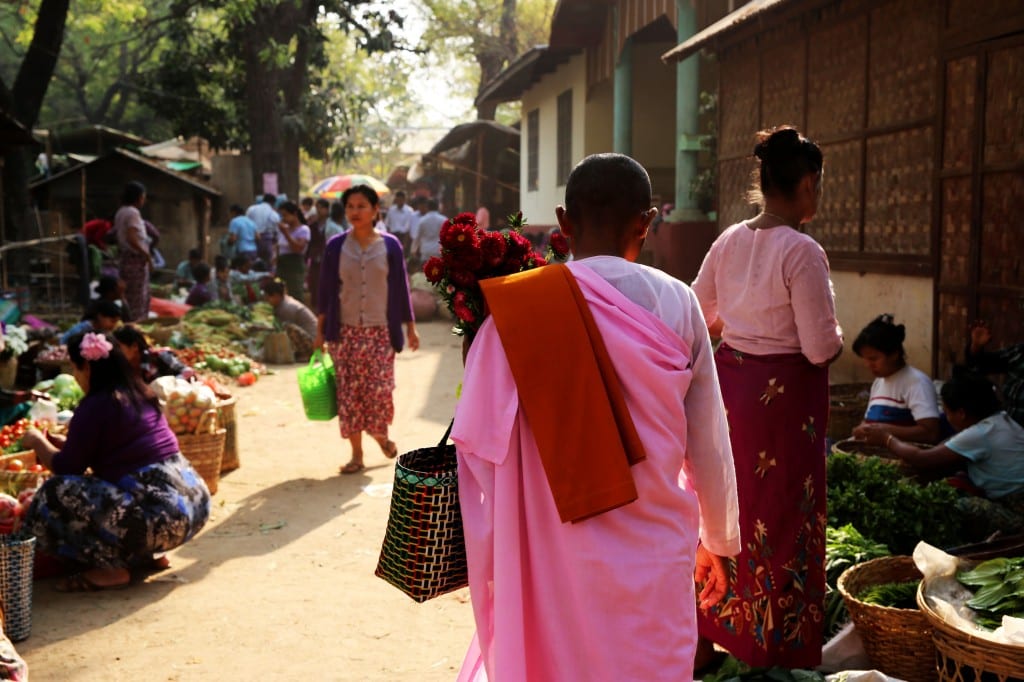 nun walks through market Burma 